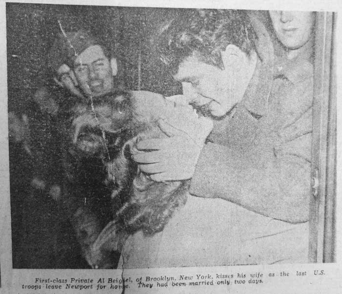 First Class Private Al Beigiel, of Brooklyn, New York, kisses his wife as last U.S. troops leave Newport for home. They have been married only two days.