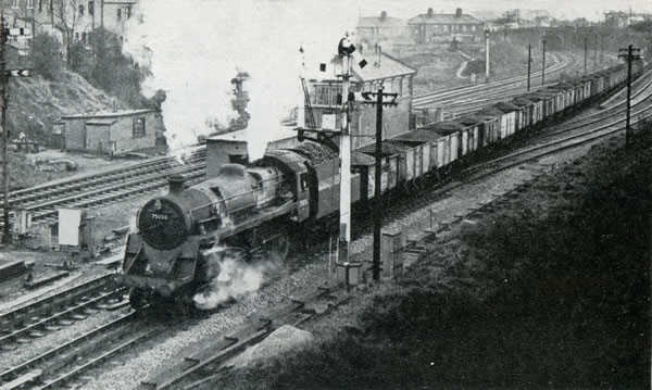 Freight train, hauled by B.R. standard class "4" 4-6-0 No. 75008, passing Gaer Junction, west of Newport High Street Station