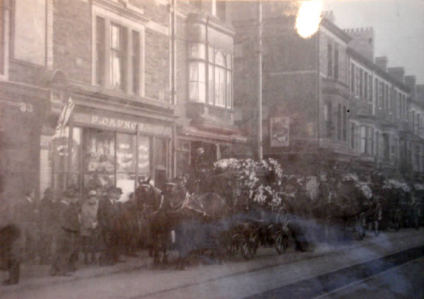 The funeral cortege of Rebecca Capnos outside the family's tobacconist shop in Commercial Road.