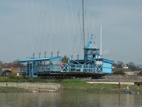 The control cabin of the travelling platform of the Newport transporter bridge has a "Pagoda" roof. The 30 cables carrying the platform are crossed to form triangular trussing to prevent swaying in high winds. Photograph © Newport Past 2010.